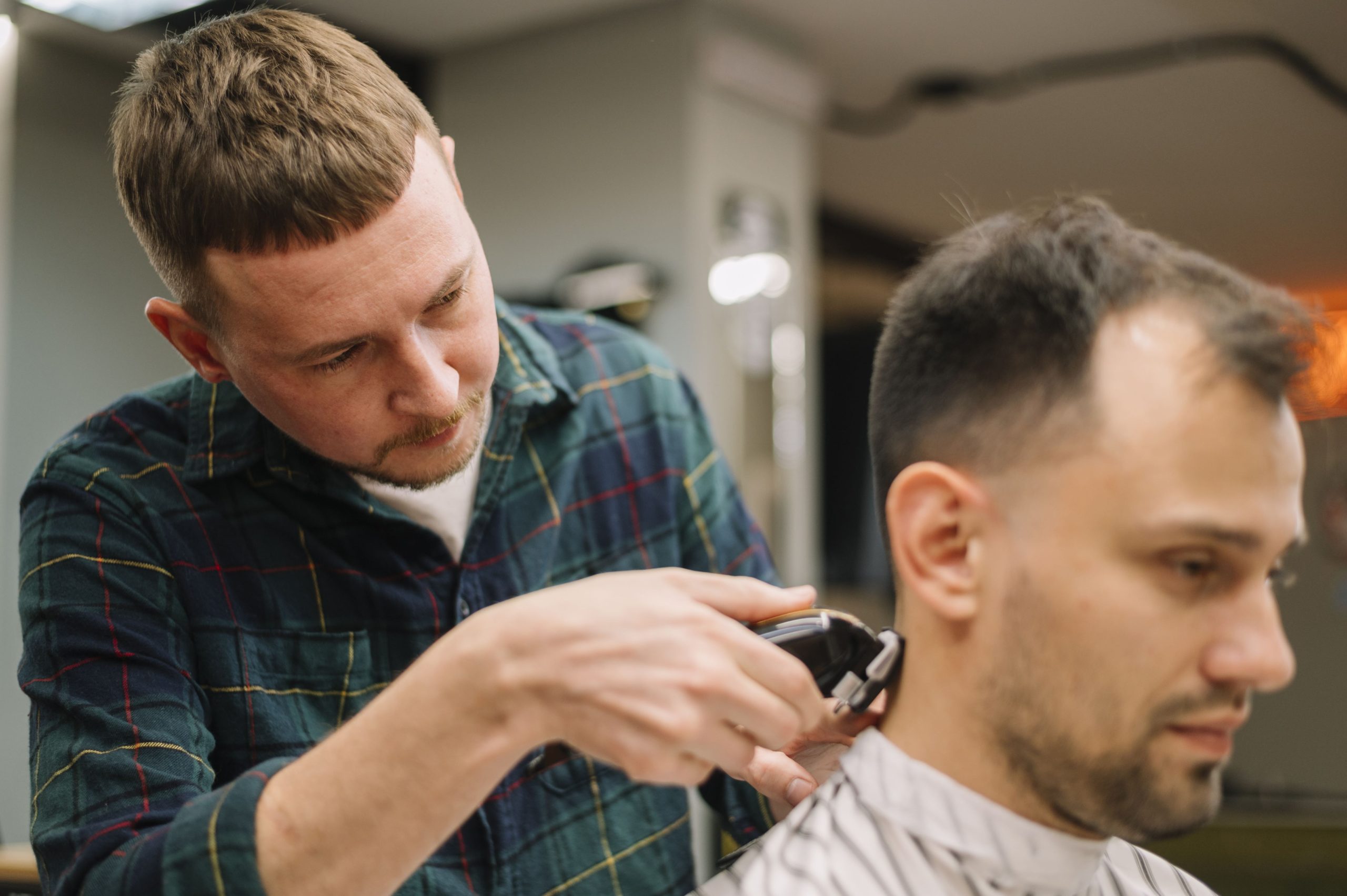 white man getting a haircut in barber's shop